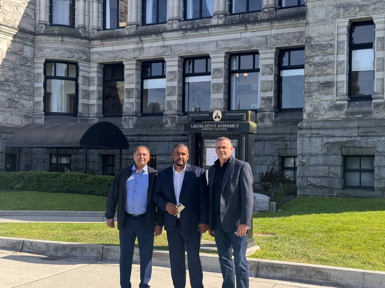 Three Port Transportation Association representatives standing outside the Legislative Assembly of British Columbia in Victoria